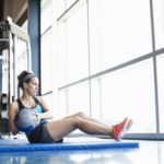 woman-exercising-with-medicine-ball-in-fitness-center-175137952-59d37f38d088c000116ade48