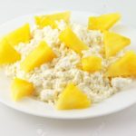 4369172-heap-of-cottage-cheese-with-slices-of-pineapple-in-white-plate-