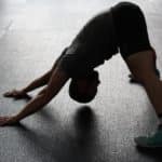 man-in-grey-shirt-doing-yoga-on-gray-ceramic-tile-floor-209887